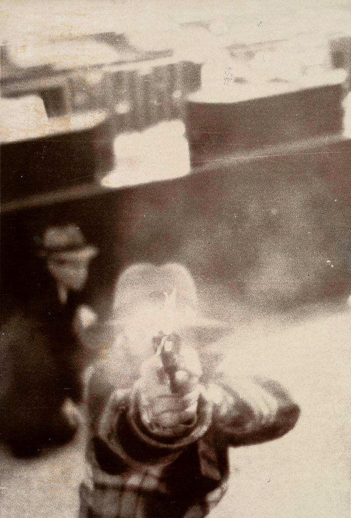 A bank thief fires at a security camera in Cleveland, 1975.