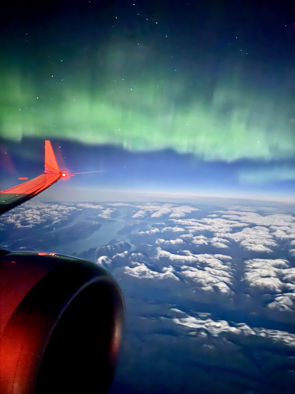 Witness the magic of a red-eye flight that captured auroras and sunrise
