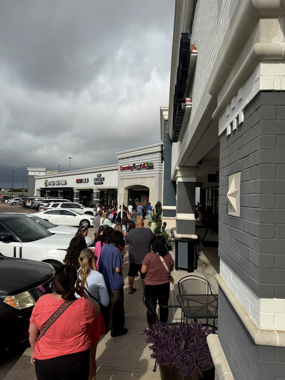 The queue outside a toy shop set to open for parents to purchase needohs for their children OC