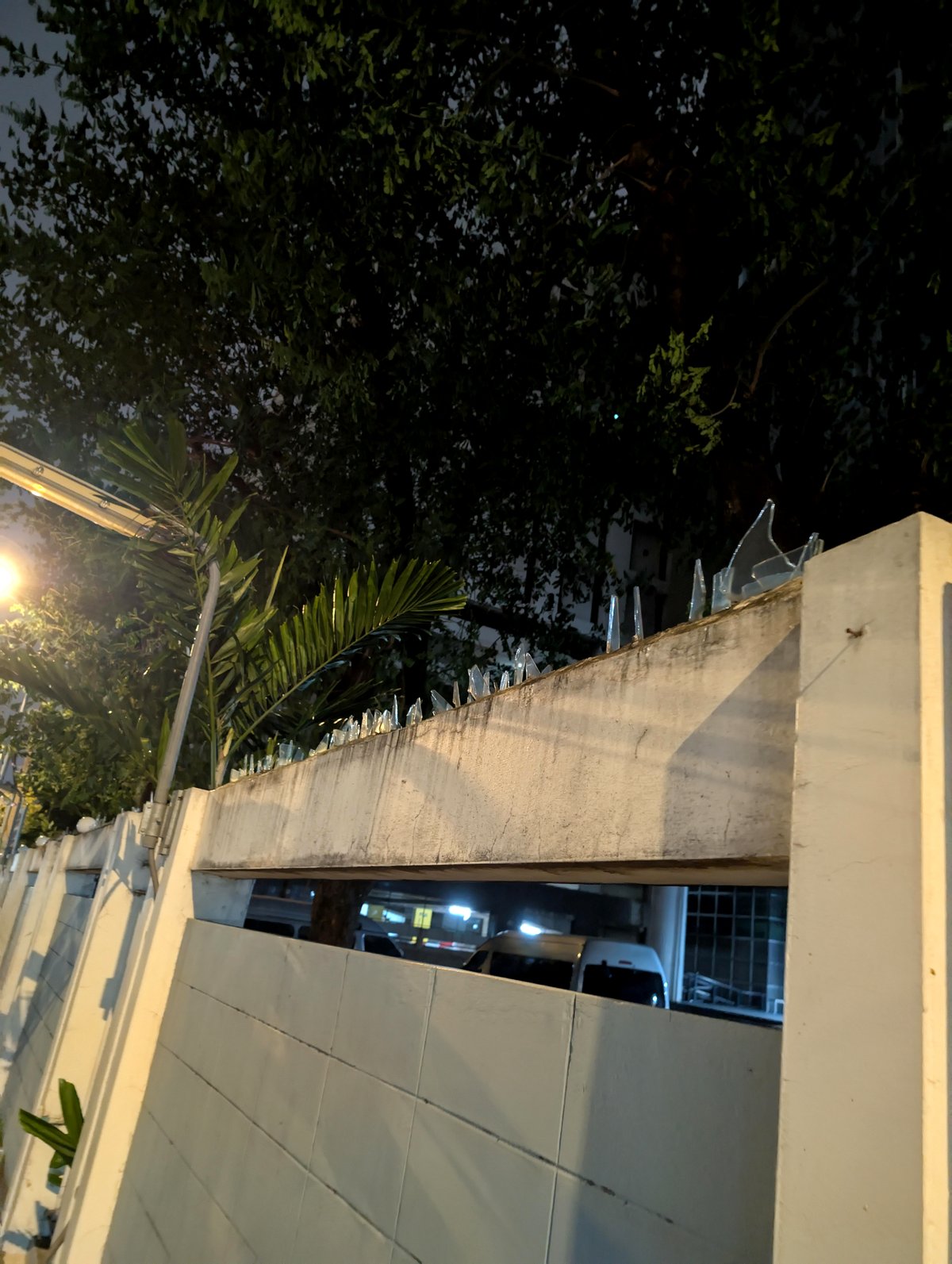 This barrier enclosing my condo features glass shards instead of barbed wire for protection.