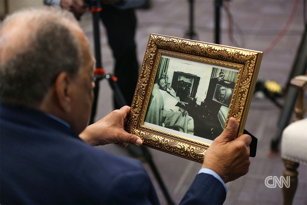 [OC] Andrew Young looks at a 1965 image of MLK Jr. observing LBJ’s Congressional address on television