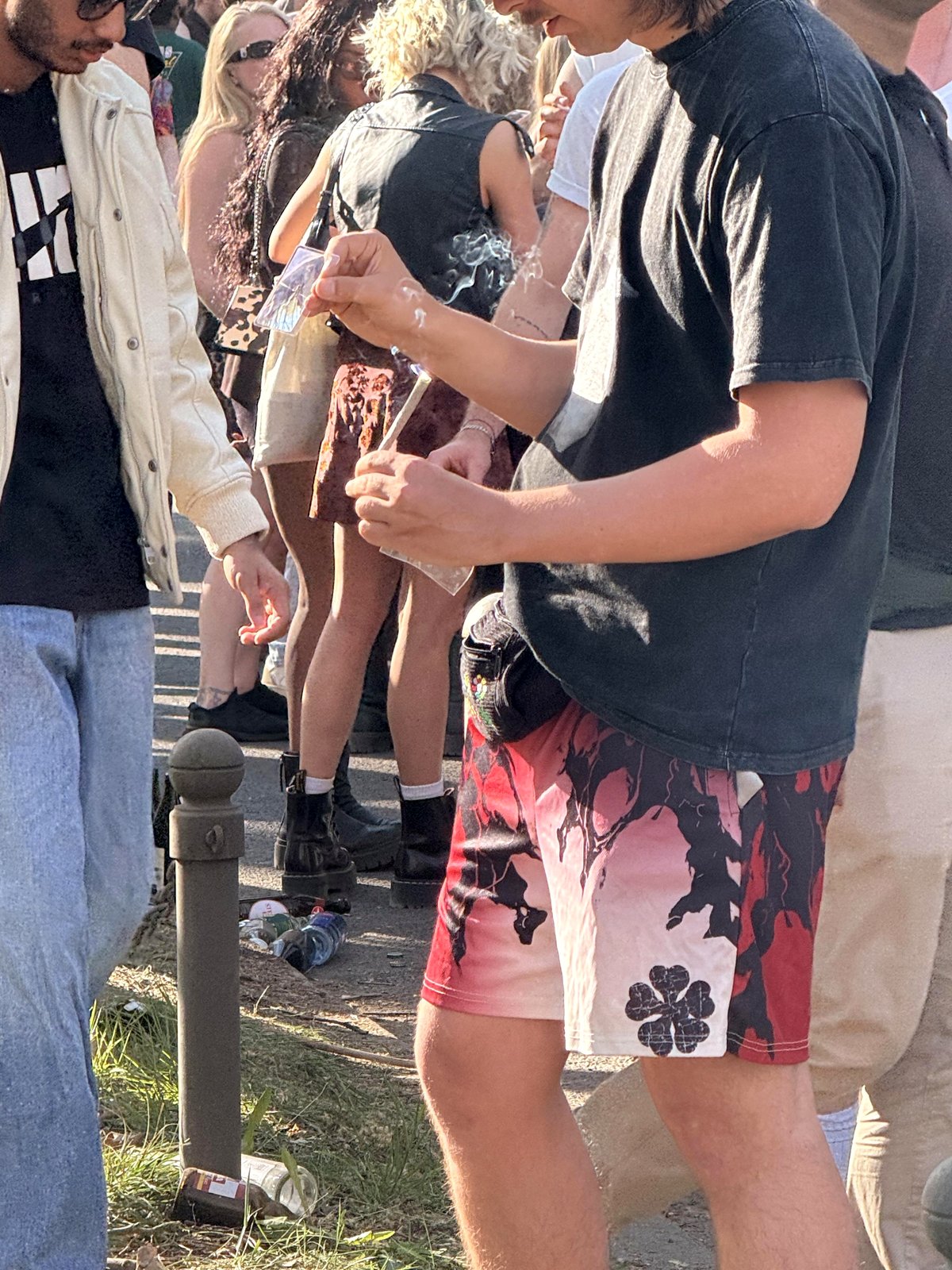 [OC] Man using a magnifying glass to light a joint on May Day in Berlin