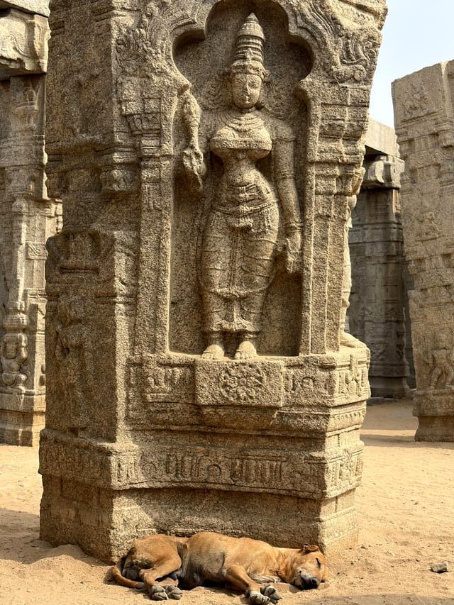 Small puppy lounging at the feet of the Mother Goddess [OC]