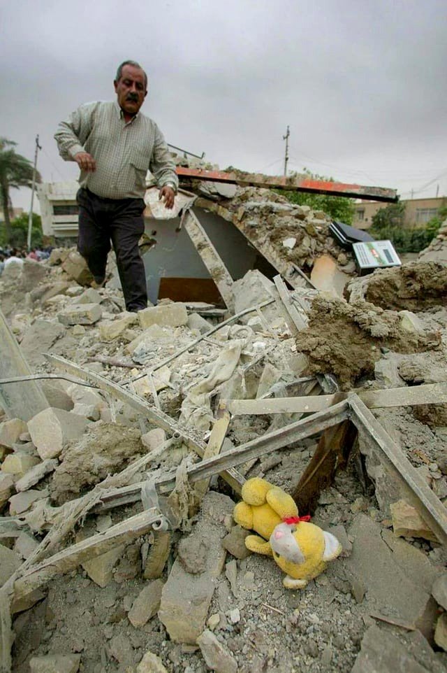 An Iraqi man looks for his relatives amidst the ruins of his devastated community.