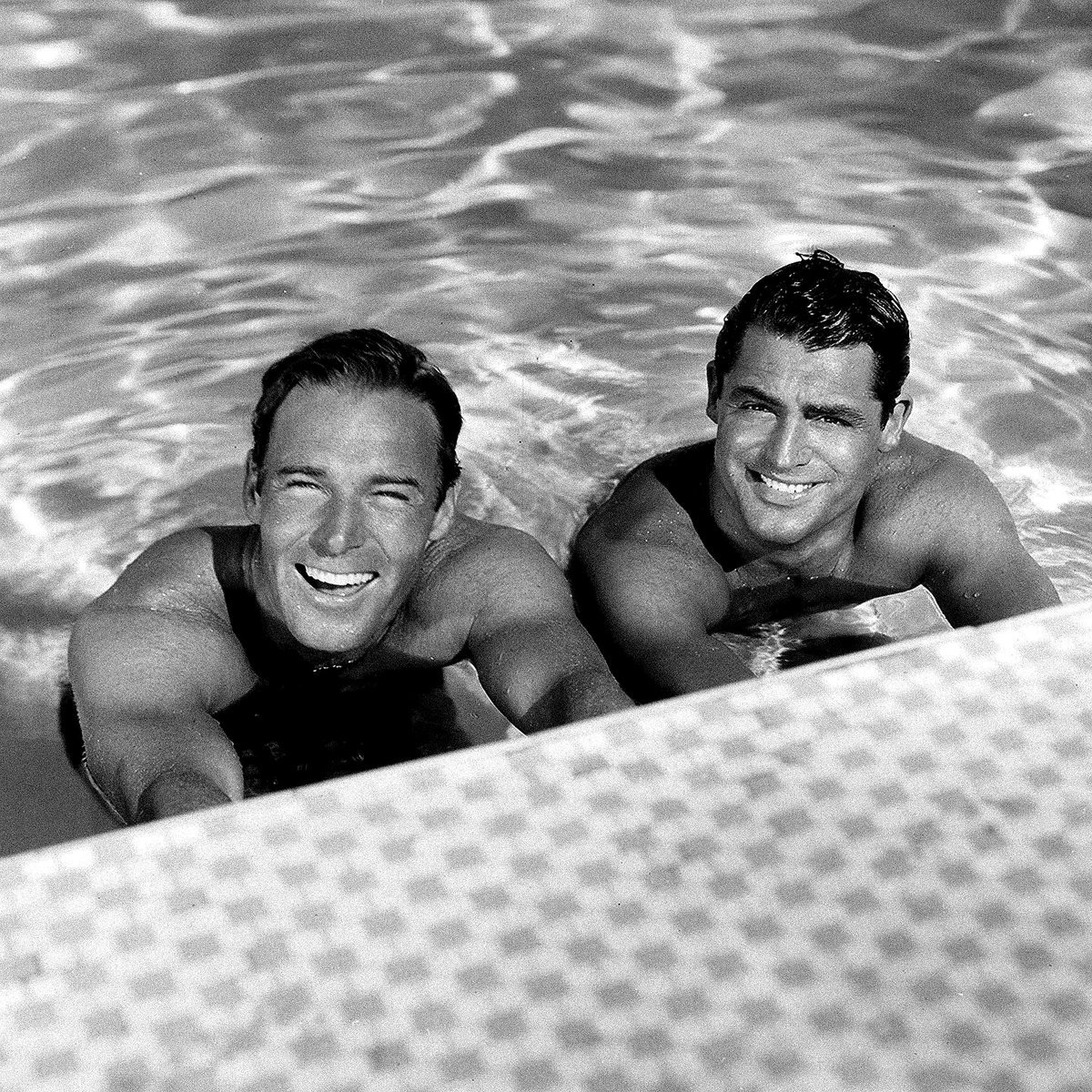 Randolph Scott and Cary Grant unwinding by the pool at their Santa Monica beach home known as